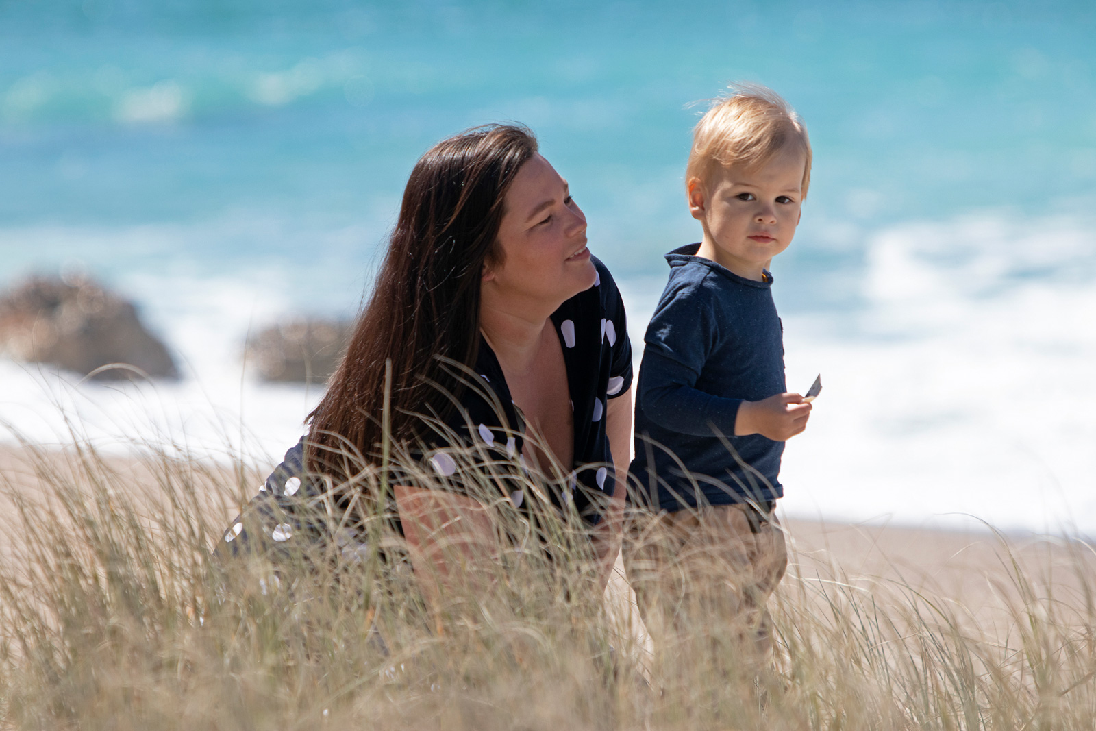 picture of mother and young son on dunes at beach