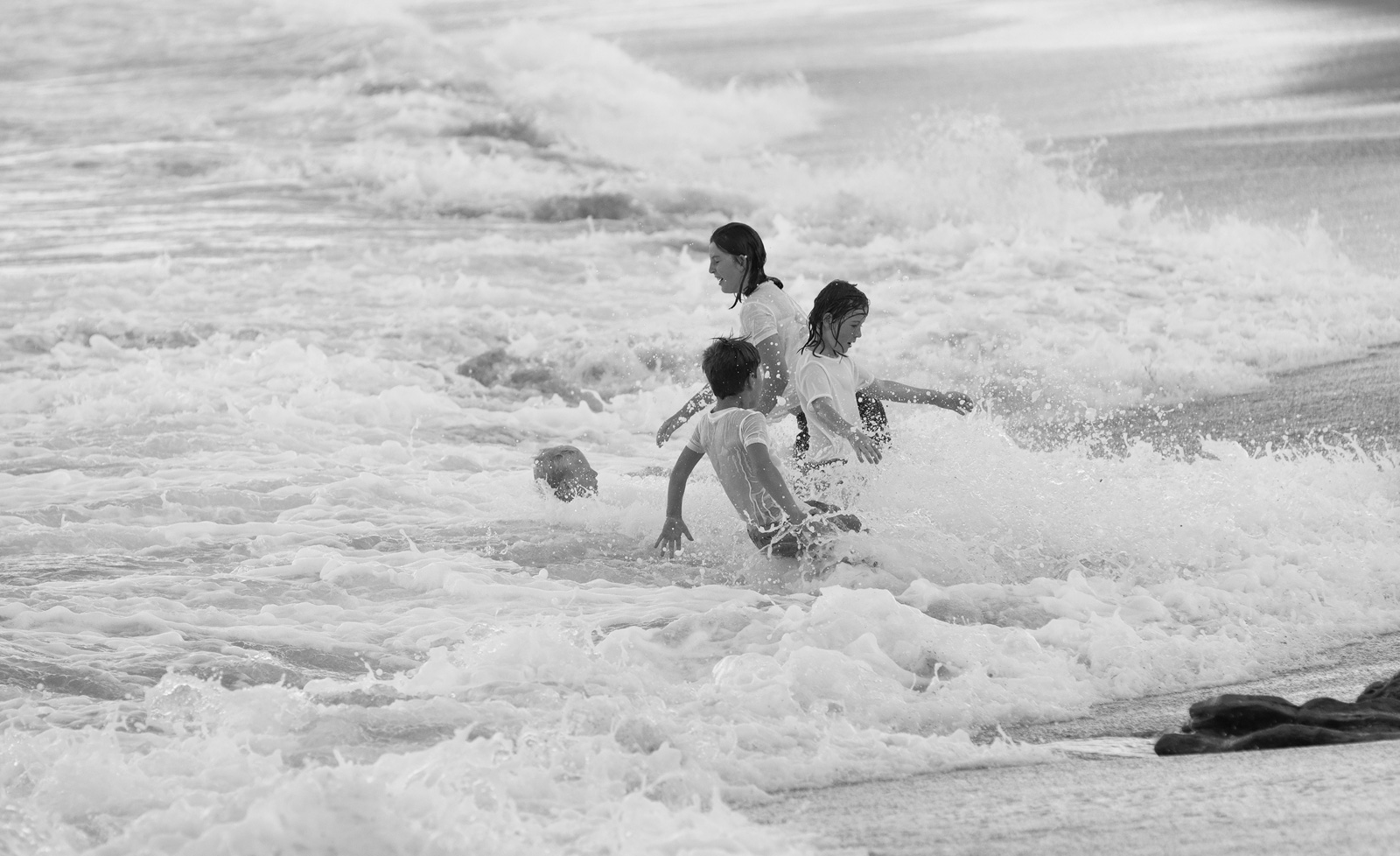 image of kids playing in surf