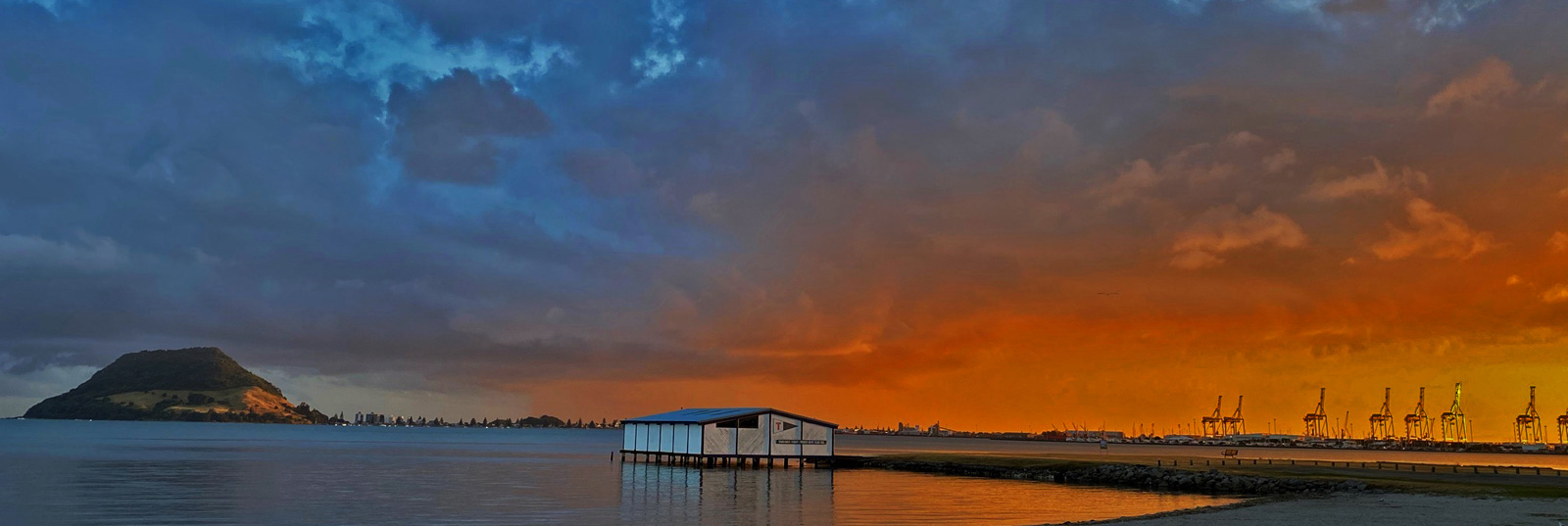 Colourful panoramic photo of sunrise at  Mt Maunganui beach